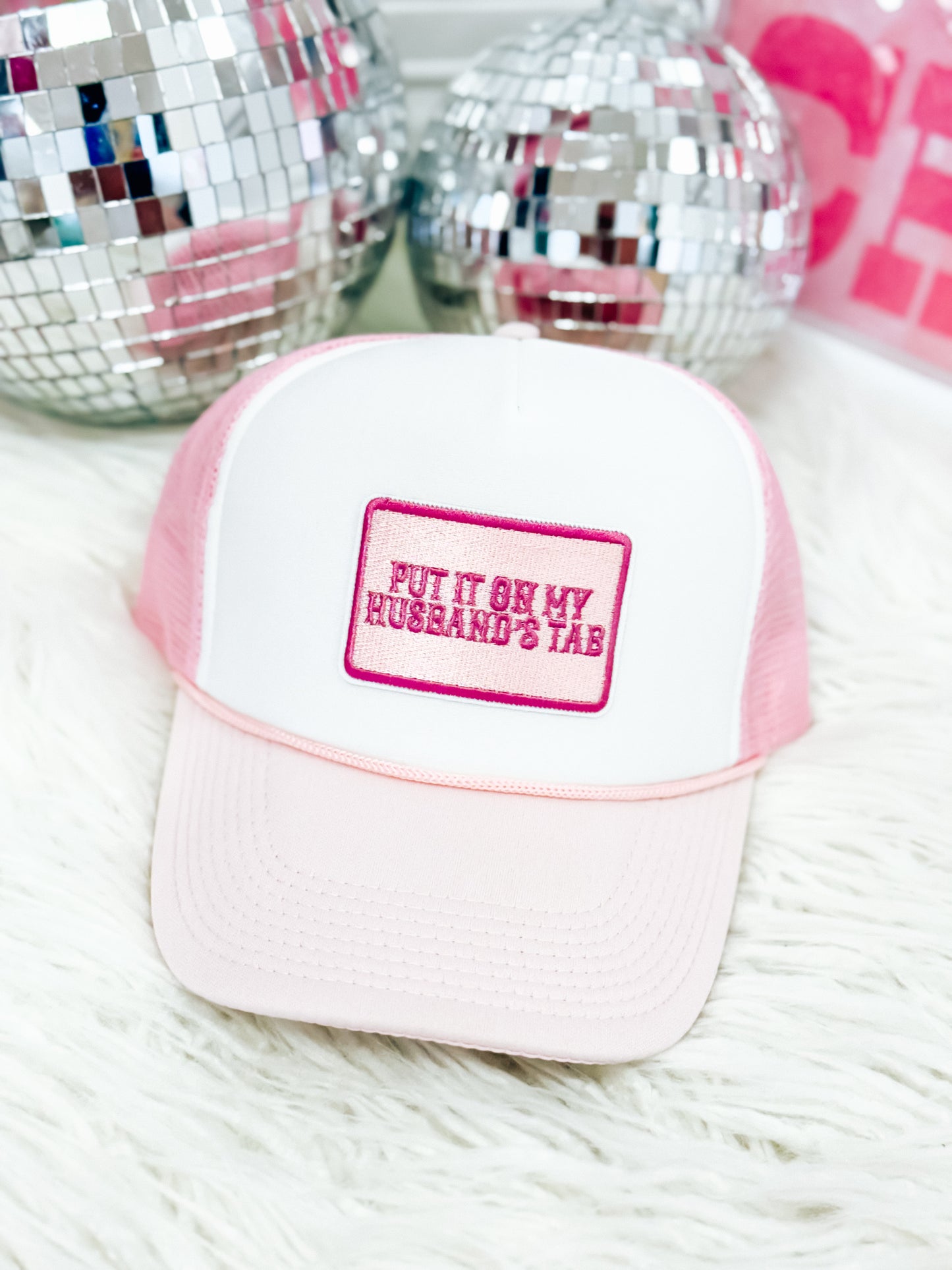 Put It On My Husband’s Tab Trucker Hats